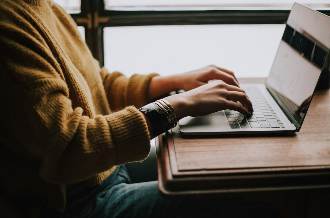 author typing on laptop